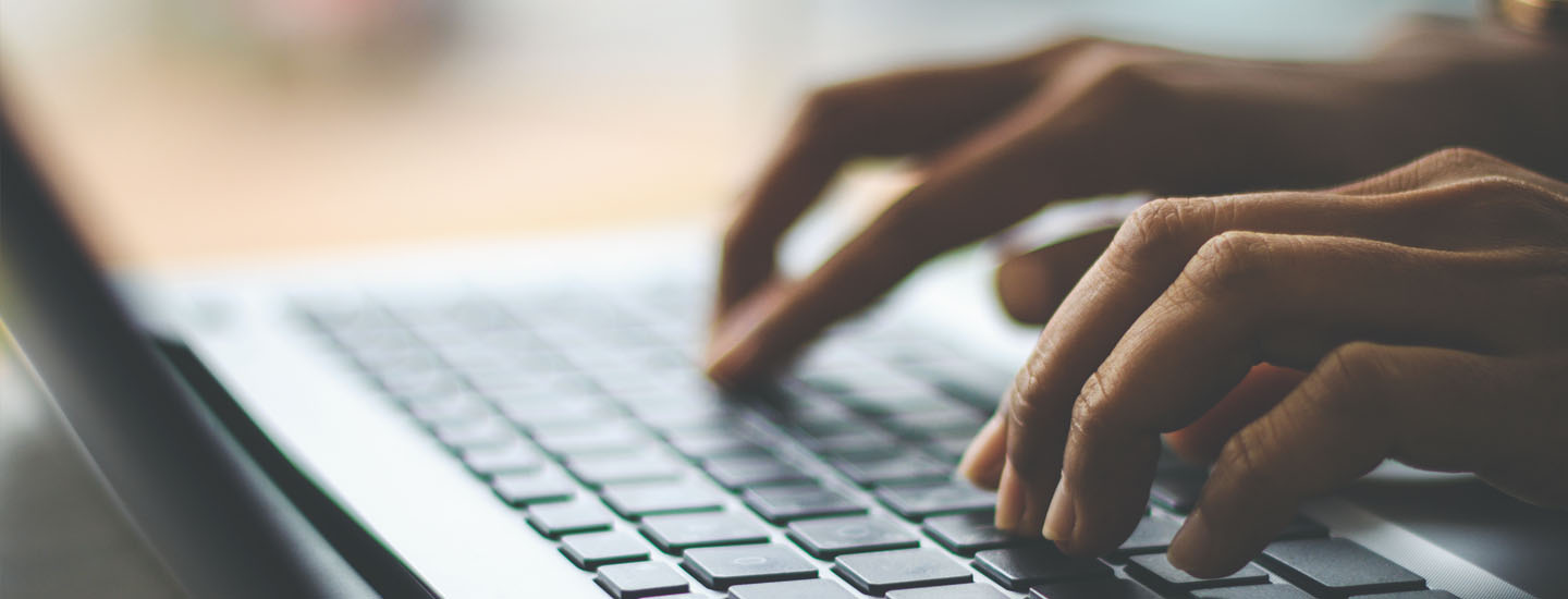 Person typing on a keyboard