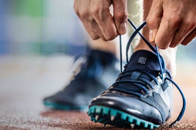 Person tying running shoes